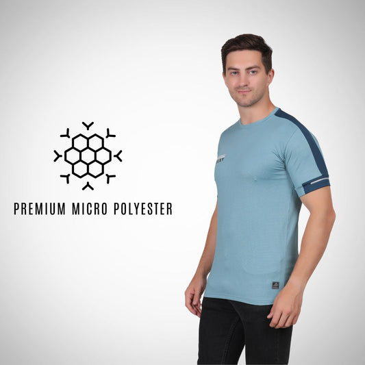 Man wearing a light blue athletic shirt with dark blue sleeves on a white background, featuring a premium micro polyester logo.