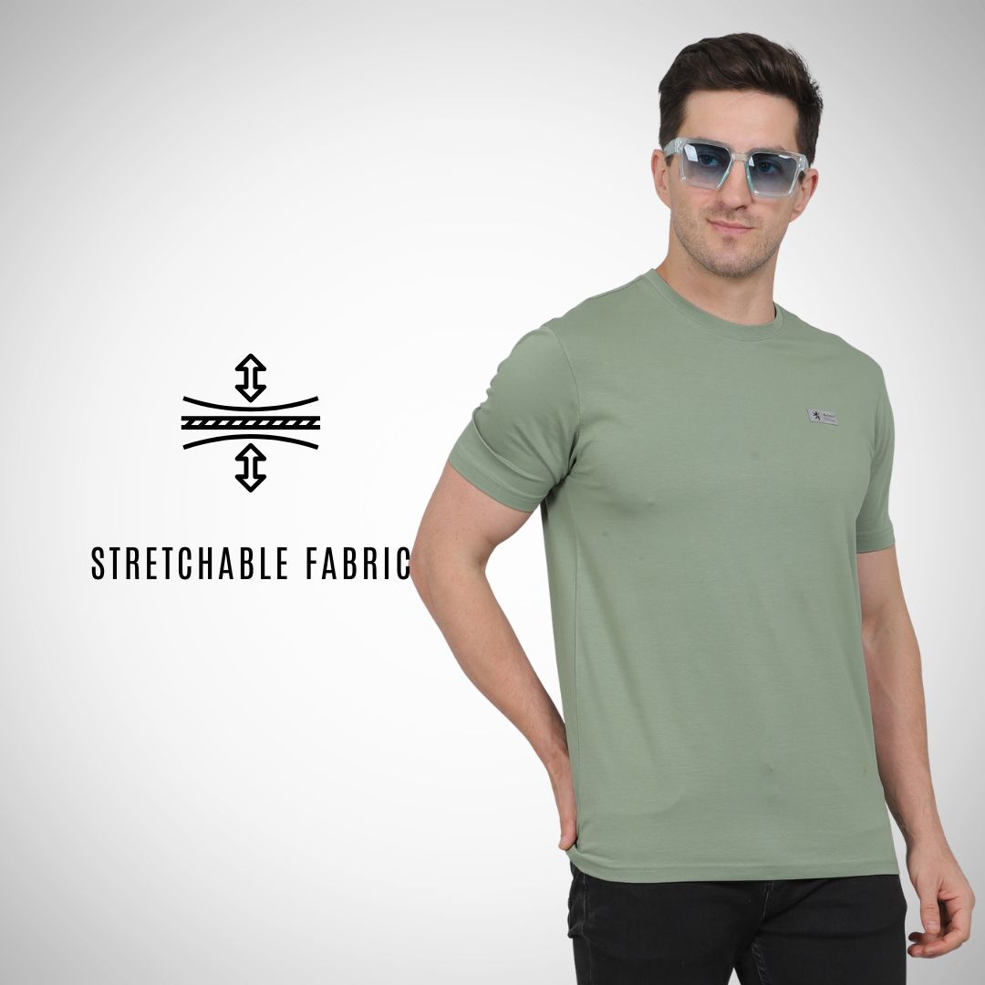 Man wearing a green t-shirt with sunglasses on a white background