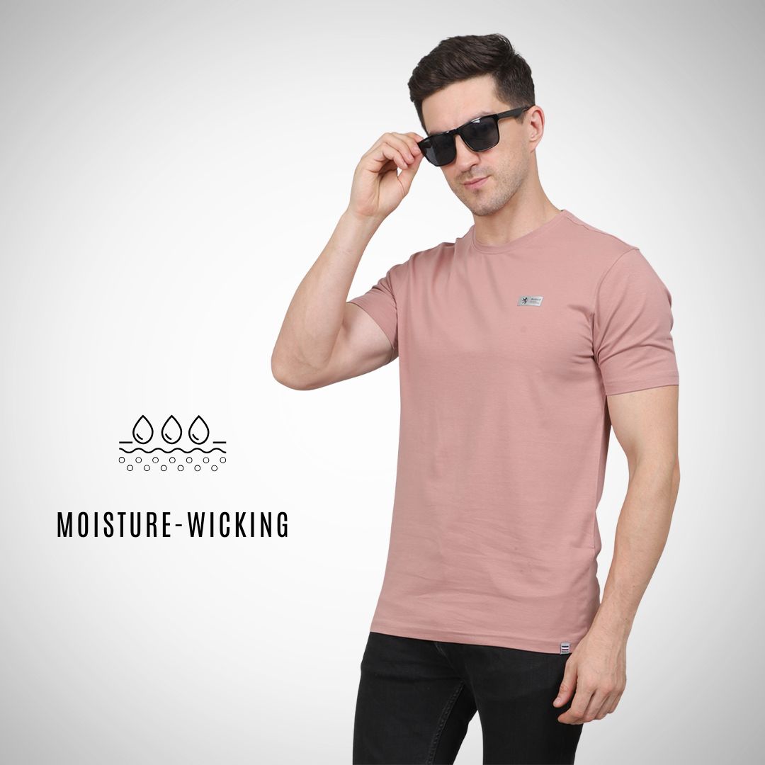 Man wearing a pink t-shirt with sunglasses, featuring moisture-wicking text on a white background