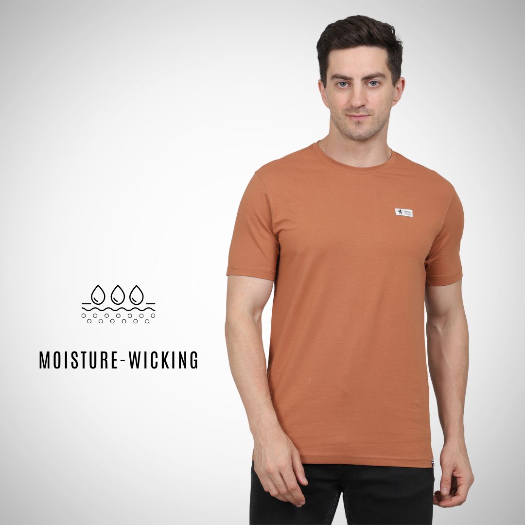 Man wearing a brown t-shirt with a logo on a white background, featuring 'Moisture-Wicking' text.