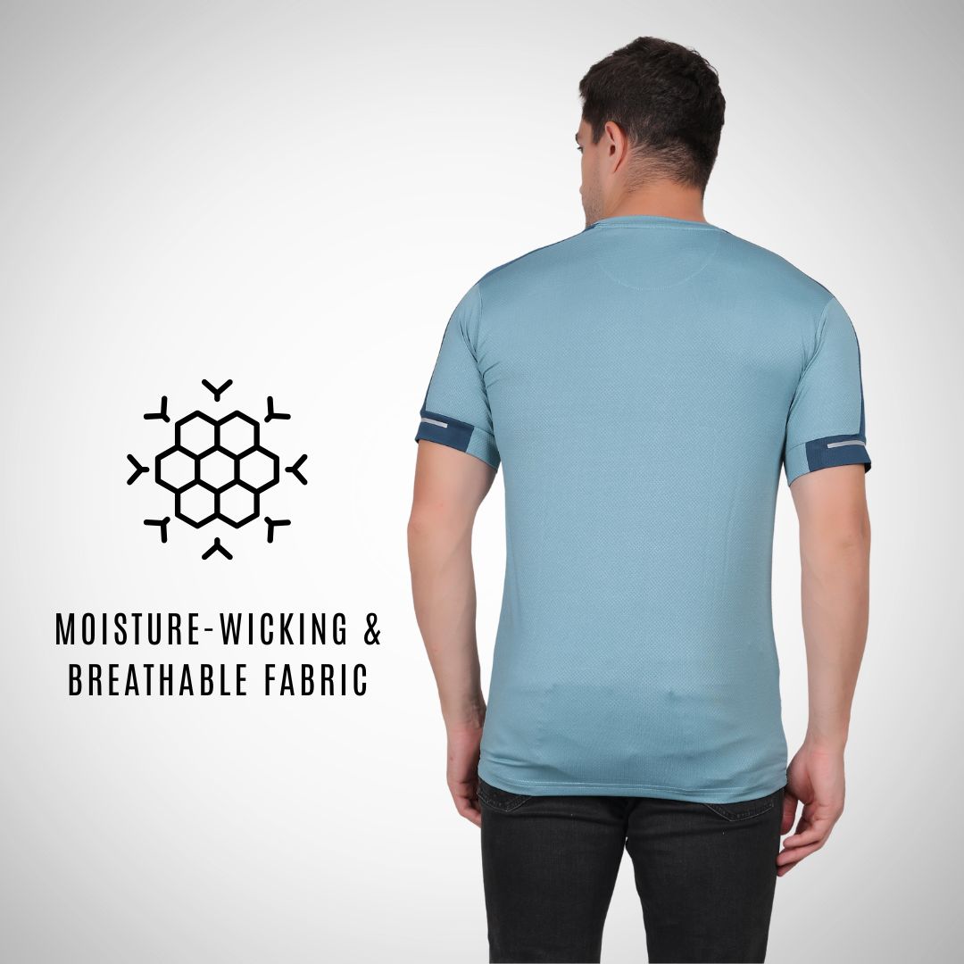Man wearing a light blue t-shirt with moisture-wicking and breathable fabric text and logo.