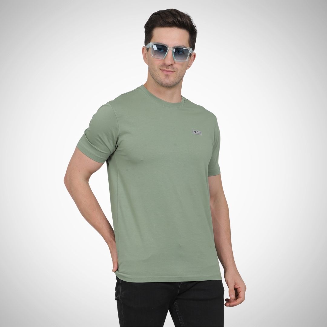 Man wearing a green t-shirt and sunglasses on a white background